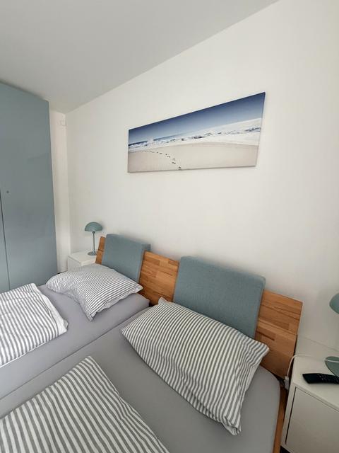 Freshly made double bed with striped linen