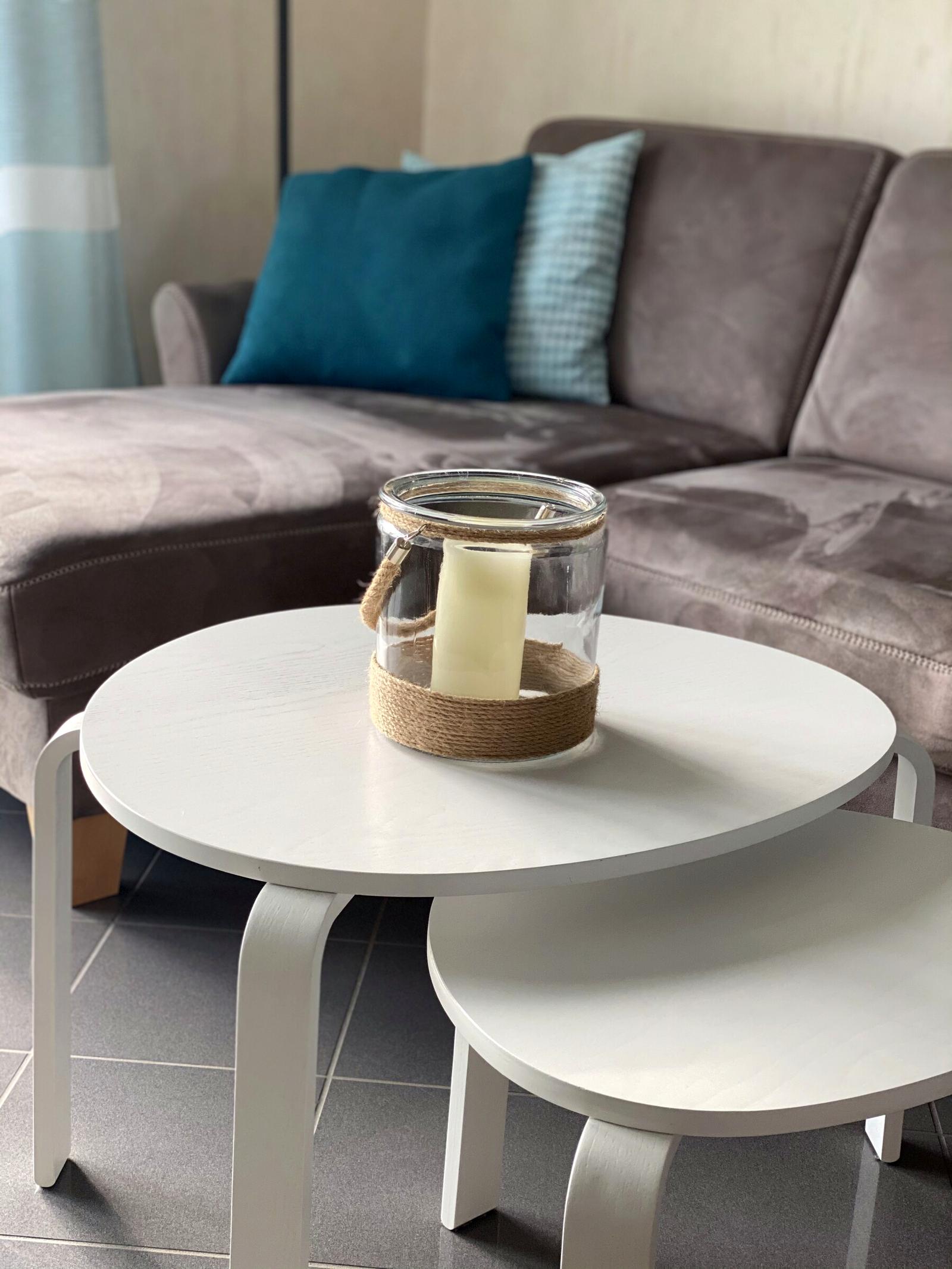 Comfortable corner sofa with teal cushions and coffee table